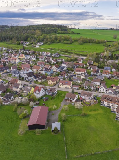 Overview of a village with scattered houses and large green spaces, surrounded by forests, Ostelsheim, Calw district, Germany
