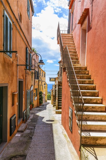 Houses with pastel-coloured façades and steep stone steps, Via Roma, Capoliveri, Elba Island, Tuscan Archipelago National Park, Tuscany, Italy