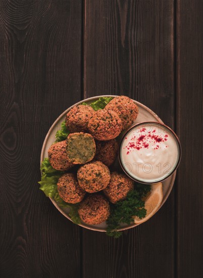 Chickpea falafel balls, on a wooden table, close-up, vegetarian food