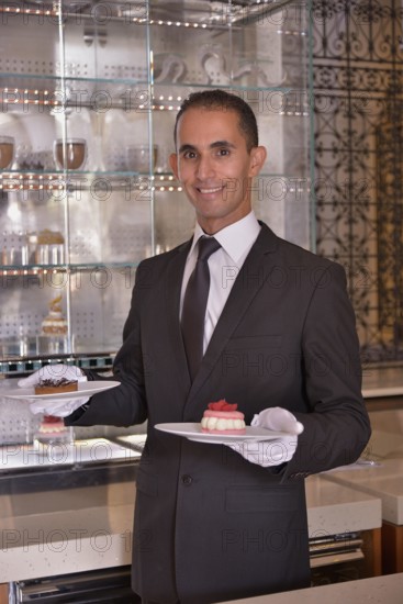 Waiter serving pastry at the Royal Mansour Hotel, Marrakesh, Marrakesh-Tensift-El Haouz region, Morocco