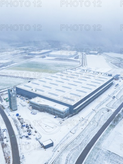 Large industrial plant in the snow, surrounded by roads, seen from the air, gives a sober winter mood, Nagold, Black Forest, Germany