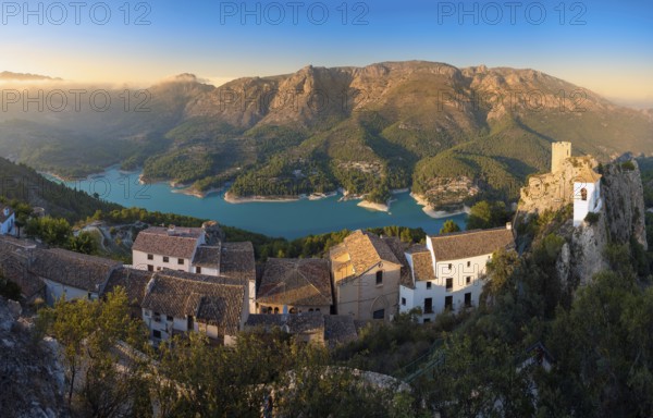 Stunning aerial and panoramic views of the medieval castle, whitewashed village, and turquoise reservoir in the picturesque valley of Guadalest, Alicante, Spain