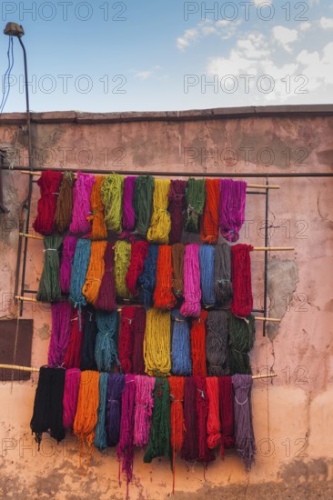 Wool for drying in the dyer's souk, colours, basic colours, presentation, wall, facade, house facade, Arabic, oriental, dyeing, assortment, shop, market, medina, bazaar, culture, craft, traditional, Marrakech, Morocco