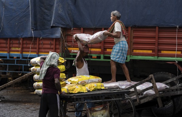 GUWAHATI, INDIA - MAY 1: Labourers carries goods in a wholesale market, in Guwahati, India, on May 1, 2025. May Day or Workers Day is a global holiday celebrated on May 1st to honor workers and their contributions