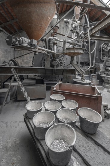 Bucket with zinc flakes in the production room with the metal powder grinding mill for the production of zinc powder, metal powder mill, founded in 1900, Middle Franconia, Bavaria, Germany