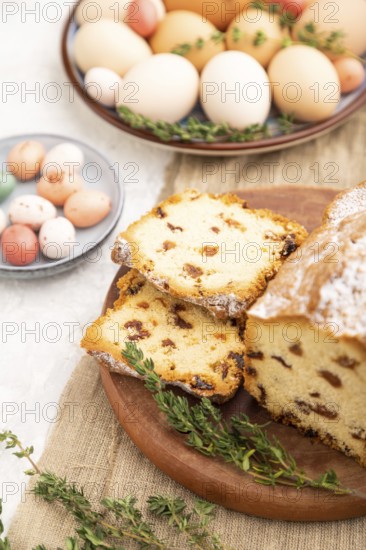 Homemade easter pie with raisins and eggs on plate on a gray concrete background and linen textile. side view, selective focus, close up