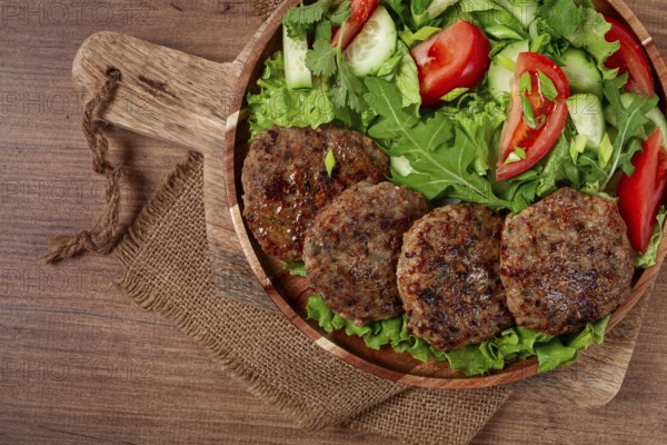Fried cutlets, mixed minced meat, with vegetable salad, homemade, top view, no people