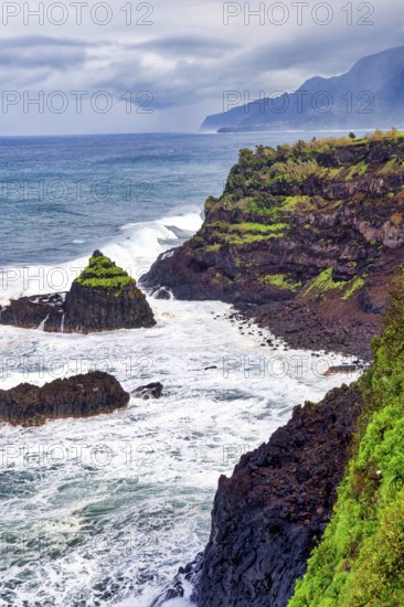Cliffs, rocky beach and Atlantic Ocean in rainy weather, Seixal, Madeira, Portugal