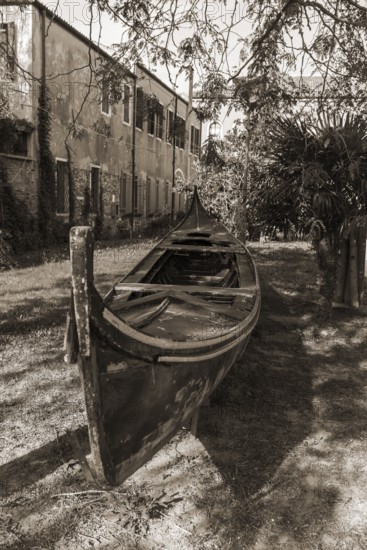 Old gondola in a garden, Giudecca Island, Veneto, Italy