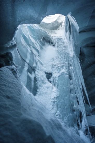 A stunning beauty of an ice cave within Katla Glacier, Iceland, captured in winter. The icy formations create a mesmerizing natural wonderland