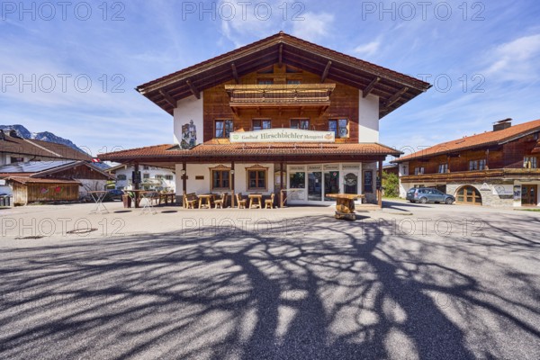 Gasthof und Metzgerei Hirschbichler, commercial building, alpine buildings, building material wood, outdoor area of a restaurant, shade of a tree, milky blue sky, cirrostratus clouds, cirrus clouds, Traunsteiner Straße, Inzell, Traunstein district, Bavaria, Germany
