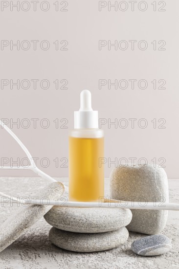 A luxury skincare oil bottle with a dropper, nestled among smooth stones Minimalist aesthetic with neutral tones creates an elegant and serene spa-like ambiance