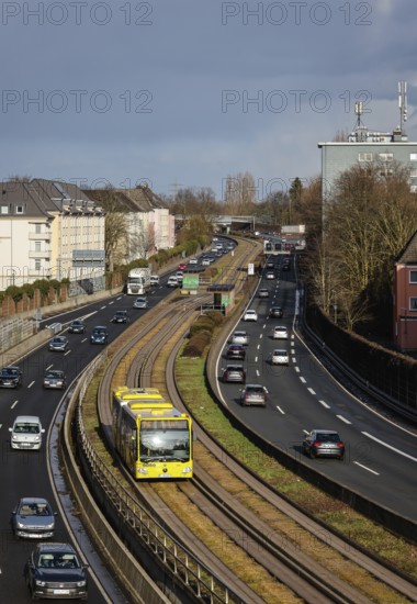 Essen, North Rhine-Westphalia, Germany - Cars and a public bus drive through Essen city centre on the A40 motorway