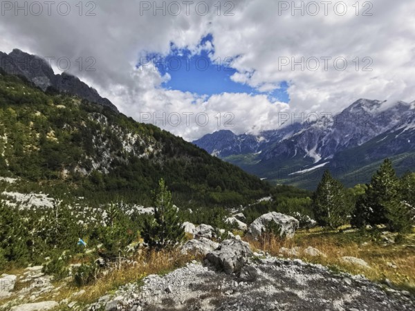 Breathtaking mountain view with dramatic clouds and wild fields, Albanian Alps National Park