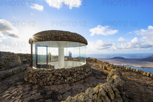 Stairway and viewing platform at the Mirador del Río viewpoint, in the evening light with sun stars, designed by artist César Manrique, view of the island of La Graciosa, Lanzarote, Canary Islands, Spain