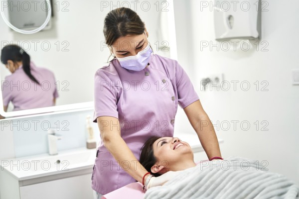 A skilled practitioner provides a soothing massage to a client in a modern beauty salon. The atmosphere is calm and focused on enhancing relaxation and self-care