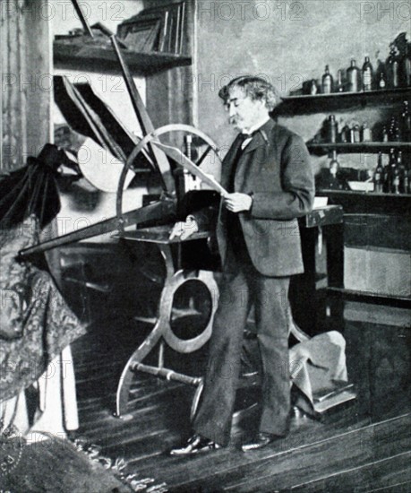 Painter James McNeil Whistler standing by his etching press (1903)