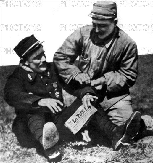 World War I. A tailor sewing senior master sergeant's stripes on the sleeve of the aviator Védrines (1915)