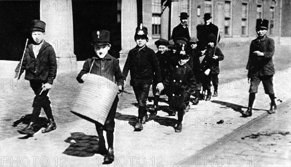 World War I. Children playing war march through the streets of The Hague (1915)