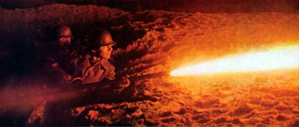 World War II. German soldiers attacking a concrete shelter at night with a flame-thrower (1941)