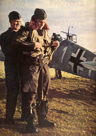 World War II. Checking the equipment of a German aviator before take-off (1941)