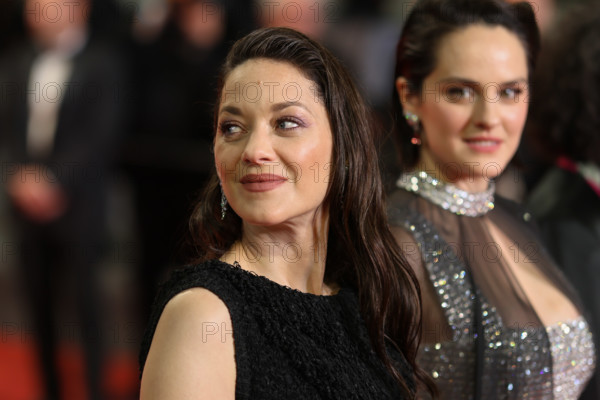Noémie Merlant (in custom Louis Vuitton) and Marion Cotillard (in custom Chanel) attend the "Roma Elastica" screening during the 79th annual Cannes Film Festival at Palais des Festivals on May 20, 2026 in Cannes, France.