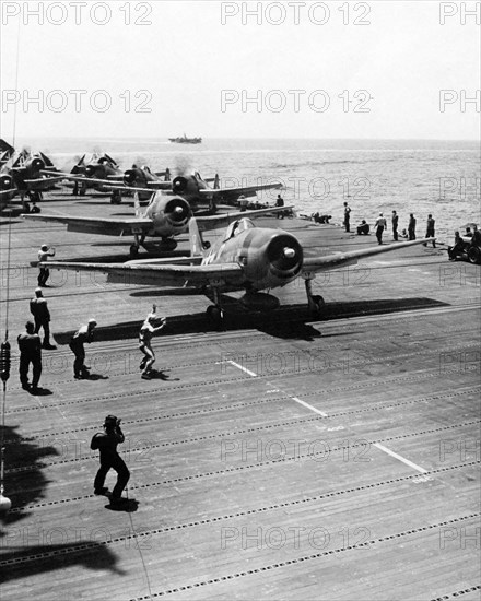 Grumman F6F-3 fighter on the deck of an American aircraft carrier