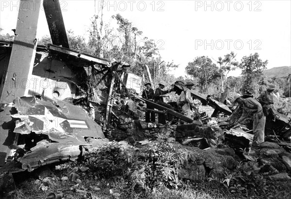South Vietnam soldiers around a destroyed American tank.
