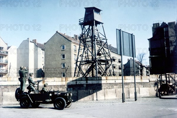 American soldiers patrolling in front of the Berlin wall