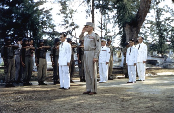 French general René Cogney, surrounded by his men, saluting the memory of soldiers killed in action in Indochina