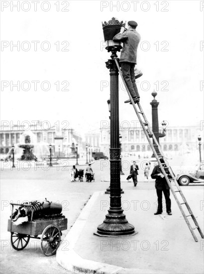 Paris. Installation of security blue lamps on public street lamps.