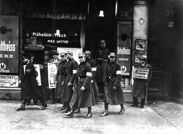 Berlin. Hitlerian Schupos going out of a shop they have just searched