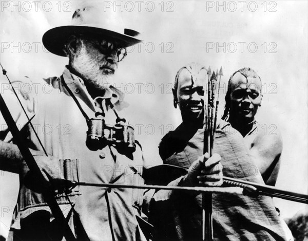 Ernest Hemingway testing an African bow
