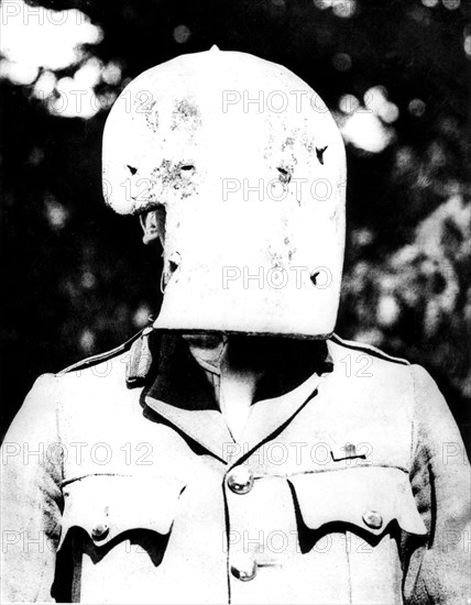 A French soldier tries a mask on, that was used in German trenchs