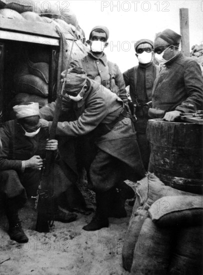 In a French trench at Nieuport. Zouaves equipped with masks against poison gases