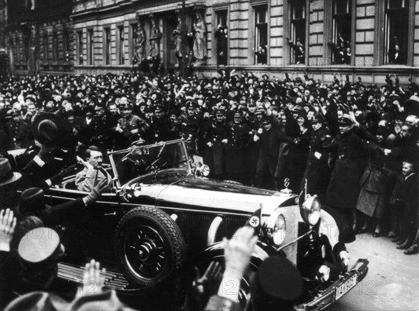 Hitler leaving the Reichstag through the cheering crowd