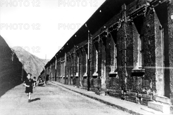 Child running before the miners' terraced houses in Henin-Lietard