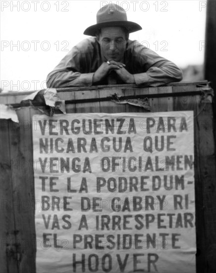 American soldier above a sign in Nicaragua, during President Hoover's visit