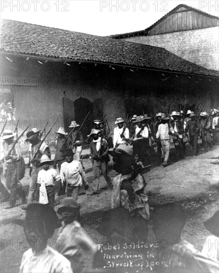 Rebel soldiers marching in the street in Leon