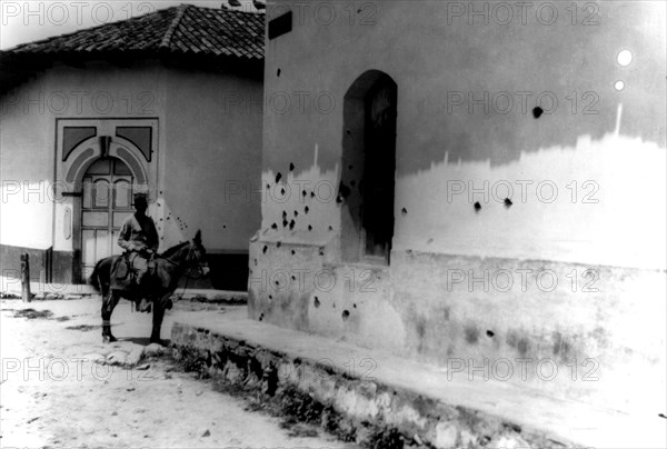 Wall pocked with bullet holes during machine gun fire by Sandino's rebel forces