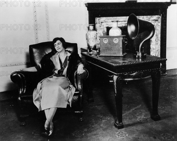 Woman listening to a Marconi speaker.