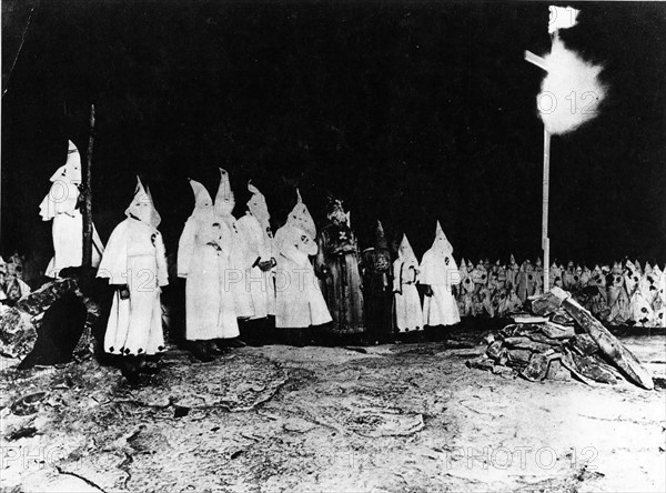 Demonstration of Ku Klux Klansmen burning a cross