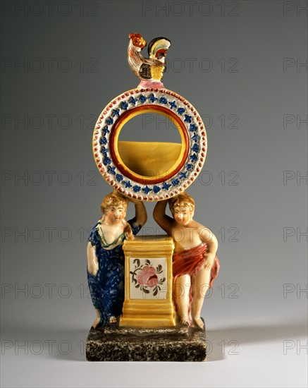 Watch holder with putti and a rooster on the top