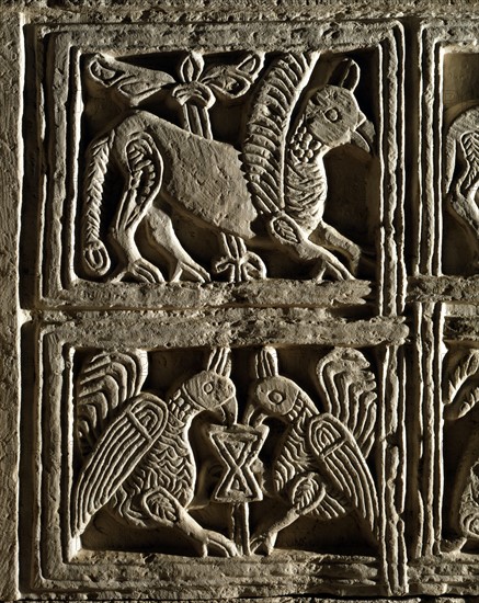 Griffin and birds facing each other around the Chalice of life