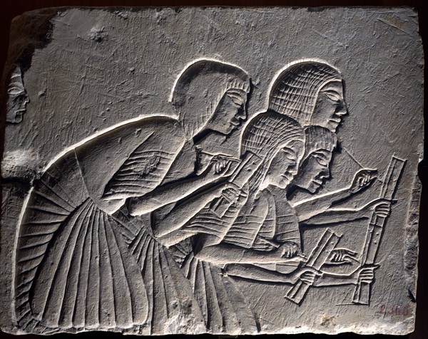 Fragment from funerary wall from Nineteenth dynasty: Group of scribes intently writing down a dictation