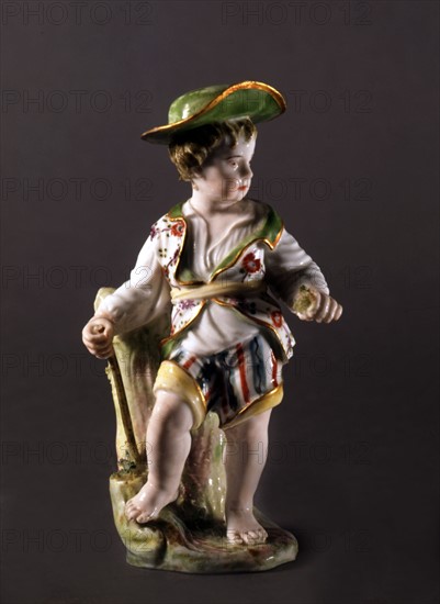 Figurine de paysan en porcelaine peinte.