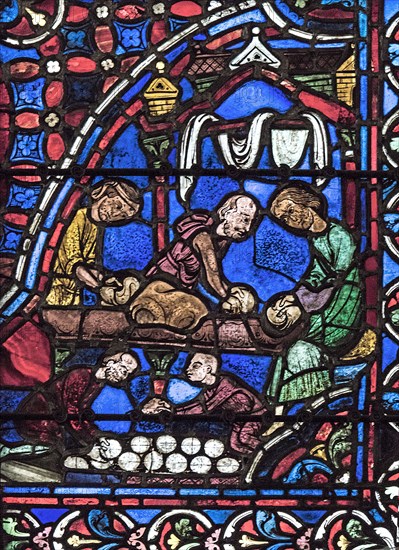 Les boulangers façonnent les boules de pain (vitrail de Chartres)