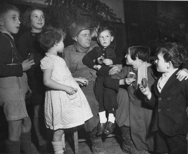 Les soldats américains jouent au père Noël pour les orphelins français à Reims (25 décembre 1944)