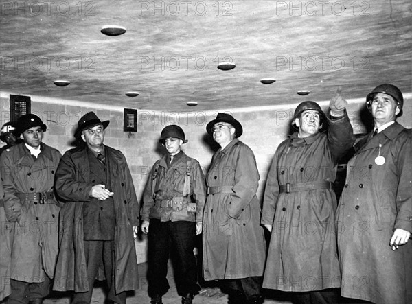Des membres du Congrès américain observent une chambre à gaz du camp de concentration de Dachau. (3 mai 1945)