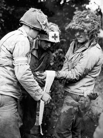 U.S Medical corps men treat wounded in St-Lo area in Normandy (France) Summer 1944.